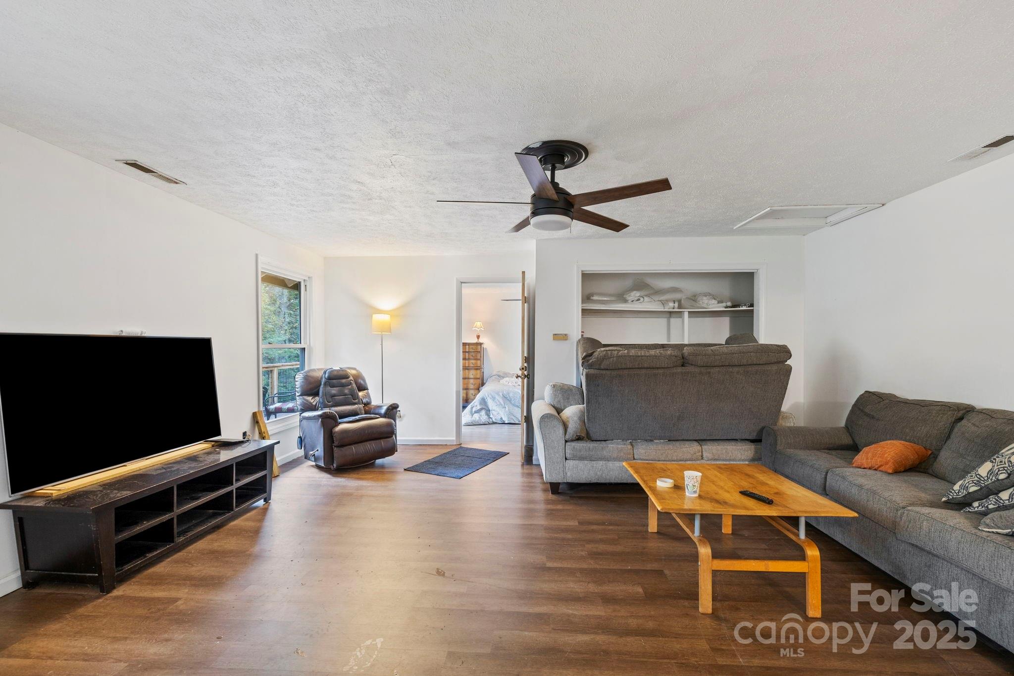 1196 North Country Club Road Brevard, NC 28712 - Photo 29 of 48 a living room with furniture and a flat screen tv