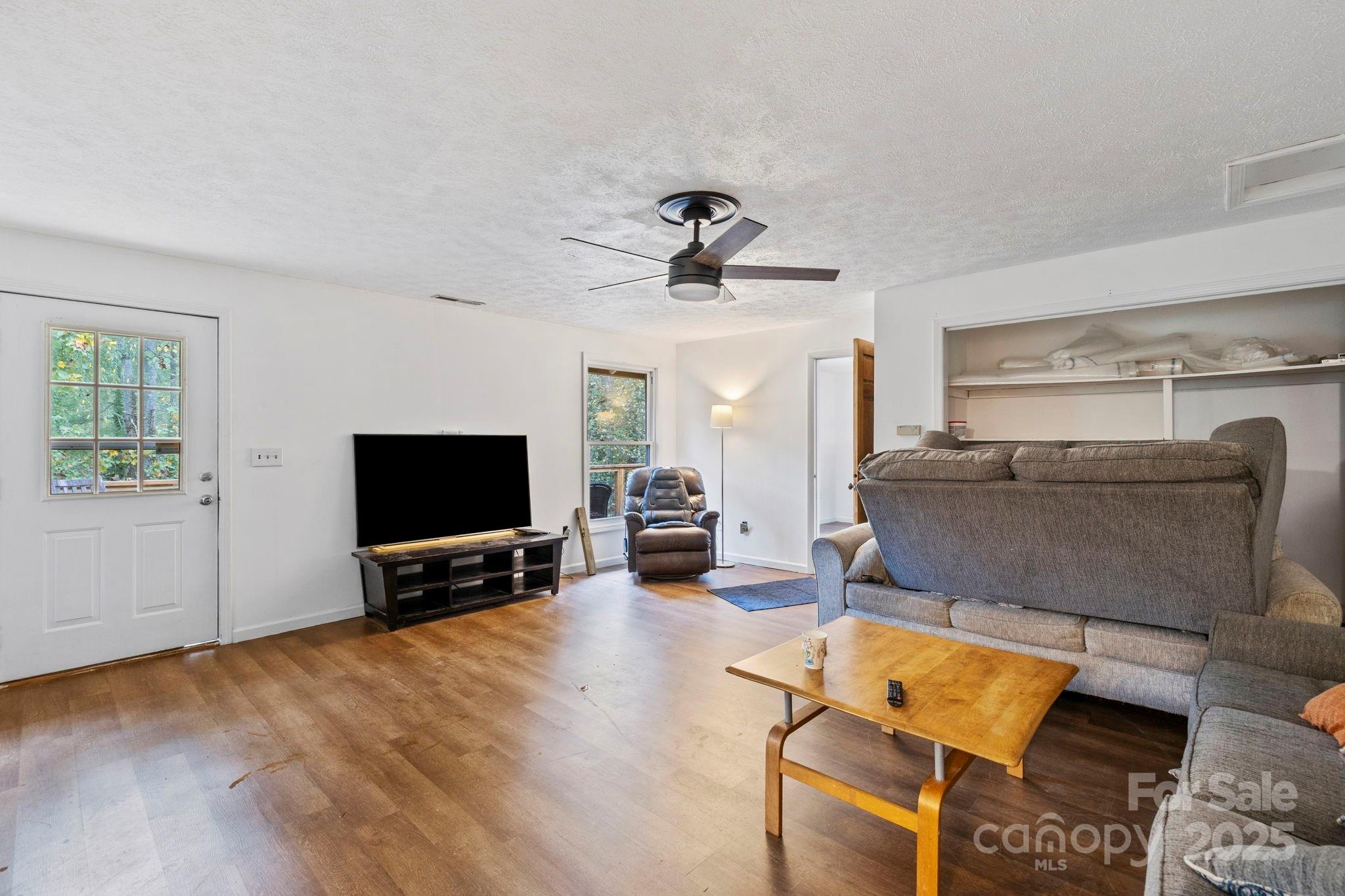 1196 North Country Club Road Brevard, NC 28712 - Photo 30 of 48 a living room with furniture and a flat screen tv