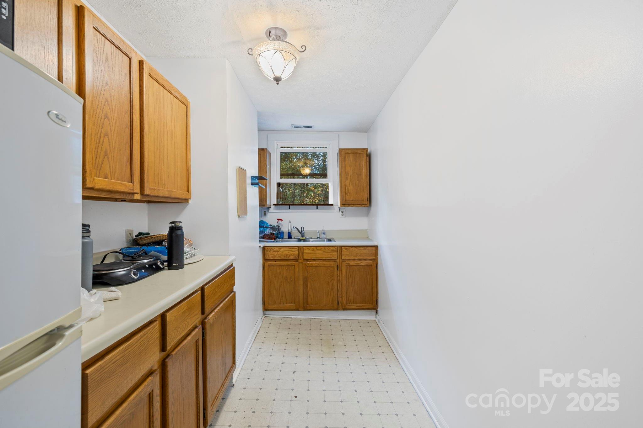 1196 North Country Club Road Brevard, NC 28712 - Photo 31 of 48 a kitchen with a stove a sink and cabinets