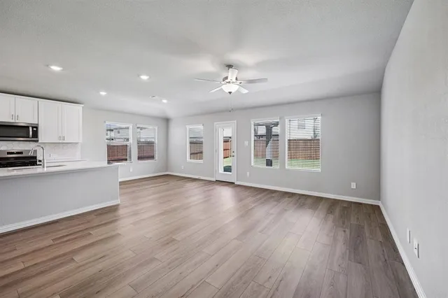 a view of a kitchen with wooden floor and a kitchen