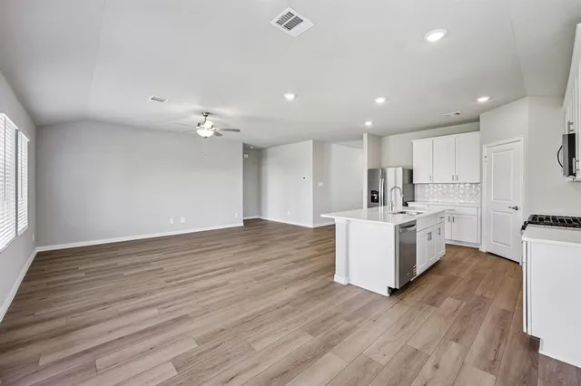 a view of kitchen with cabinets and wooden floor