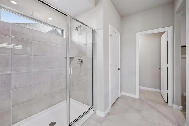 a bathroom with a glass shower door