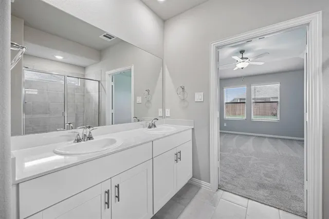 a bathroom with a double vanity sink and a mirror