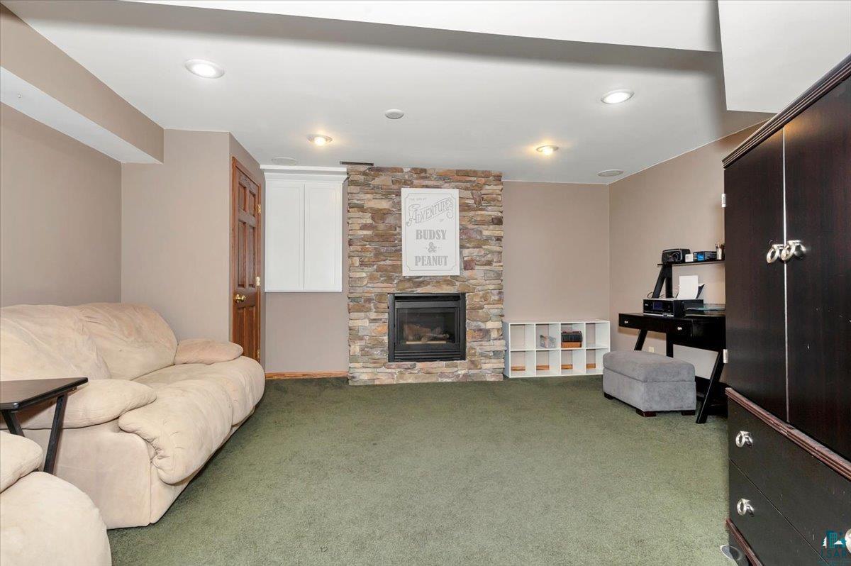 1323 South Ridge Road Duluth, MN 55804 - Photo 12 of 31 Carpeted living room featuring a stone fireplace