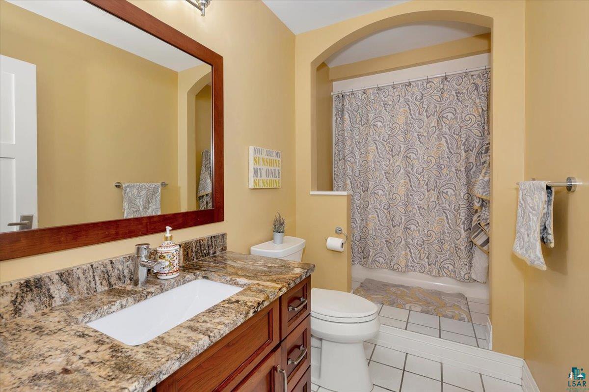 1323 South Ridge Road Duluth, MN 55804 - Photo 18 of 31 Bathroom featuring vanity, toilet, and tile patterned flooring