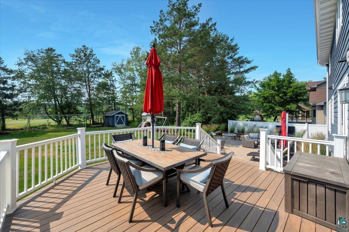 1323 South Ridge Road Duluth, MN 55804 - Photo 27 of 31 Wooden deck with a fire pit, a yard, and a storage shed