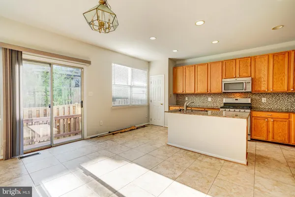 a open kitchen with a sink window and cabinets