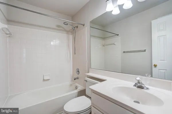 a bathroom with a sink toilet tub and shower