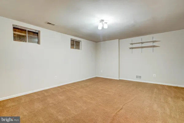 a view of an empty room with a ceiling fan
