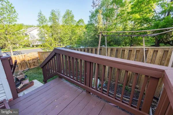 a balcony with wooden floor and fence