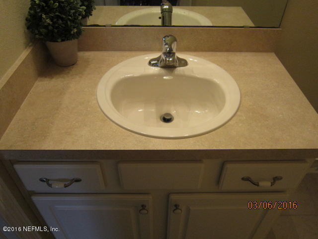 706 Crystal Way Orange Park, FL 32065 - Photo 23 of 31 a bathroom with a sink and mirror
