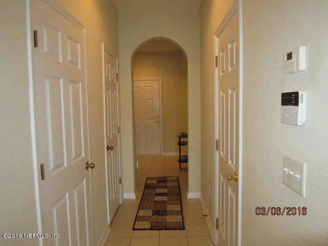 706 Crystal Way Orange Park, FL 32065 - Photo 31 of 31 a view of a hallway with a door and wooden floor