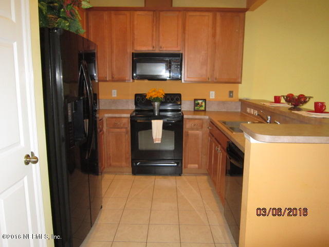 706 Crystal Way Orange Park, FL 32065 - Photo 4 of 31 a kitchen with a refrigerator stove and a sink