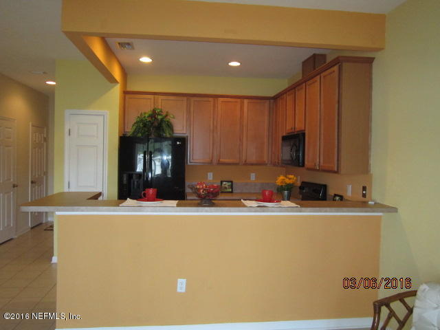 706 Crystal Way Orange Park, FL 32065 - Photo 6 of 31 a view of a kitchen with kitchen island a sink stainless steel appliances and cabinets