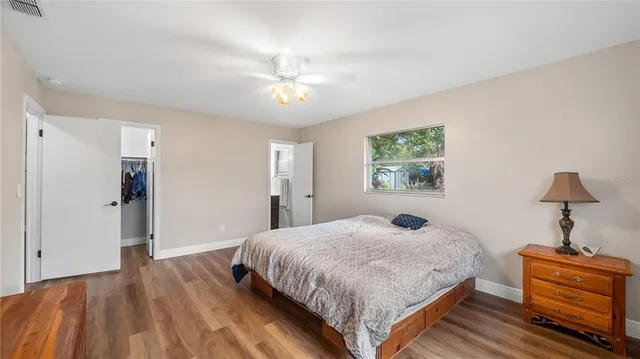 a bedroom with a bed and wooden floor