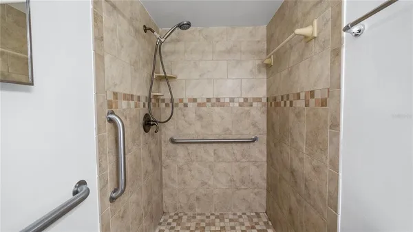 a bathroom with a glass shower door