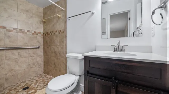 a bathroom with a sink toilet a mirror and shower