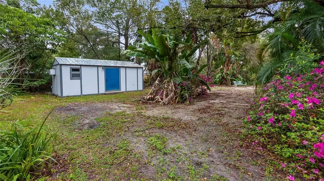 a view of a wooden house with a tree