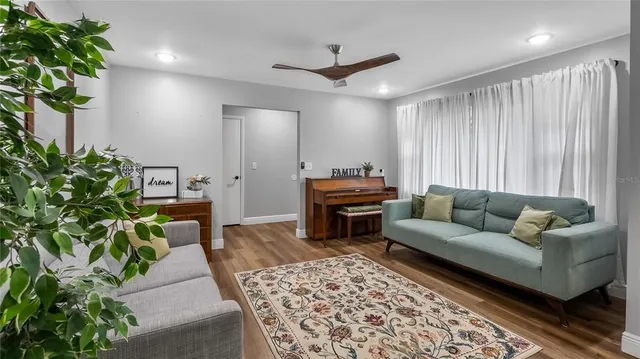 a living room with furniture and a potted plant
