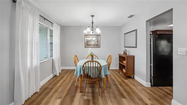 a view of a dining room with furniture window and wooden floor