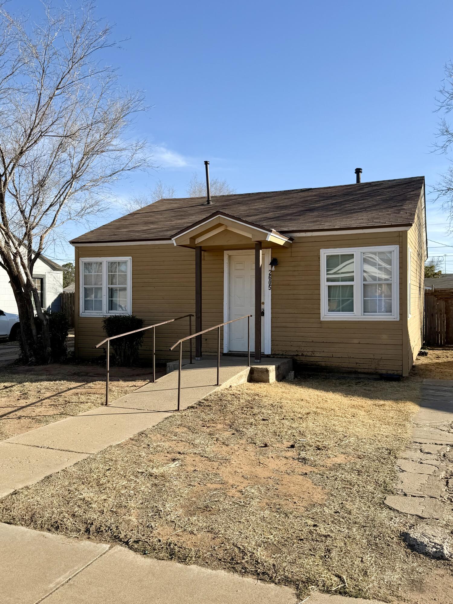 2605 1st Street Lubbock, TX 79415 - Photo 1 of 12 a backyard of a house with yard and garage