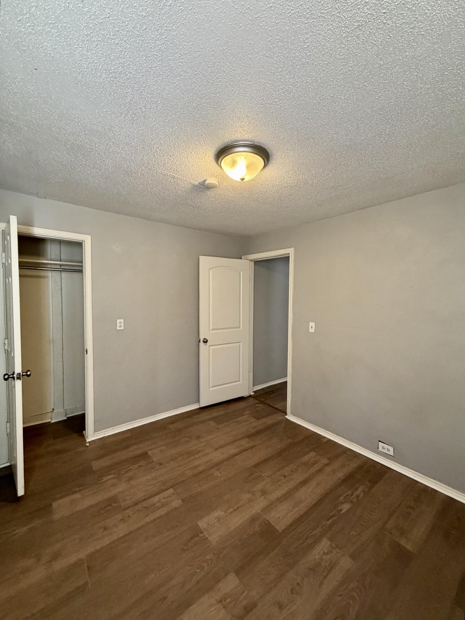 2605 1st Street Lubbock, TX 79415 - Photo 7 of 12 a view of an empty room with wooden floor and closet