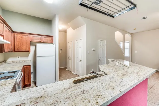 a bathroom with a granite countertop sink a mirror and shower