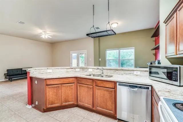 a kitchen with a stove a sink and a refrigerator