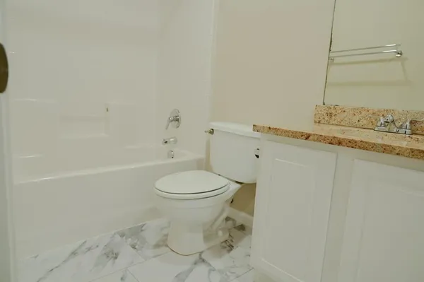 a bathroom with a toilet a sink and bathtub
