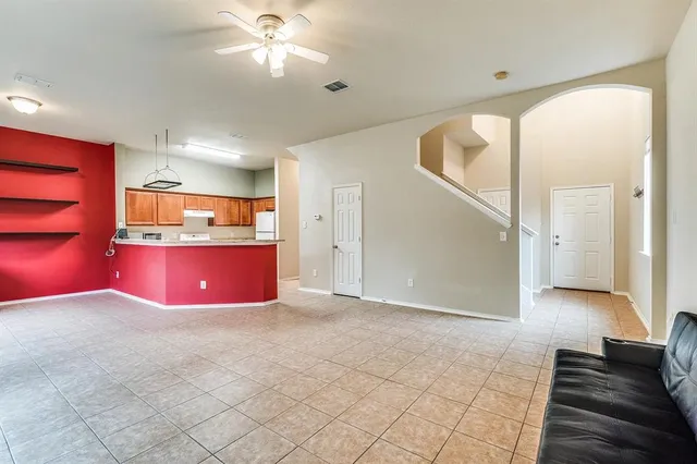 a view of kitchen with refrigerator and window