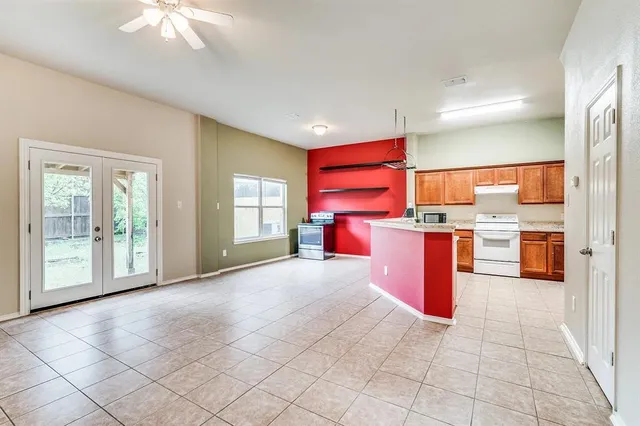 a open kitchen with stainless steel appliances granite countertop a stove sink and cabinets