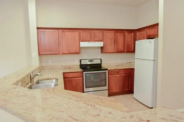 a kitchen with a refrigerator sink and stove