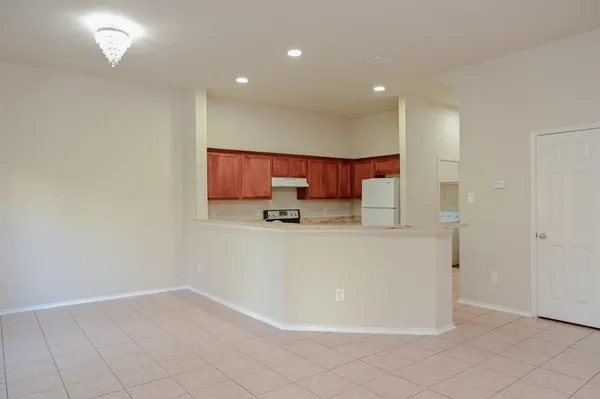 a view of kitchen with stainless steel appliances cabinets