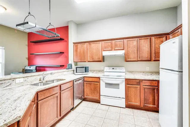 a kitchen with stainless steel appliances granite countertop a sink and cabinets