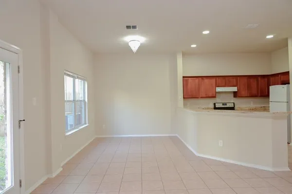a view of kitchen with granite countertop cabinets and sink
