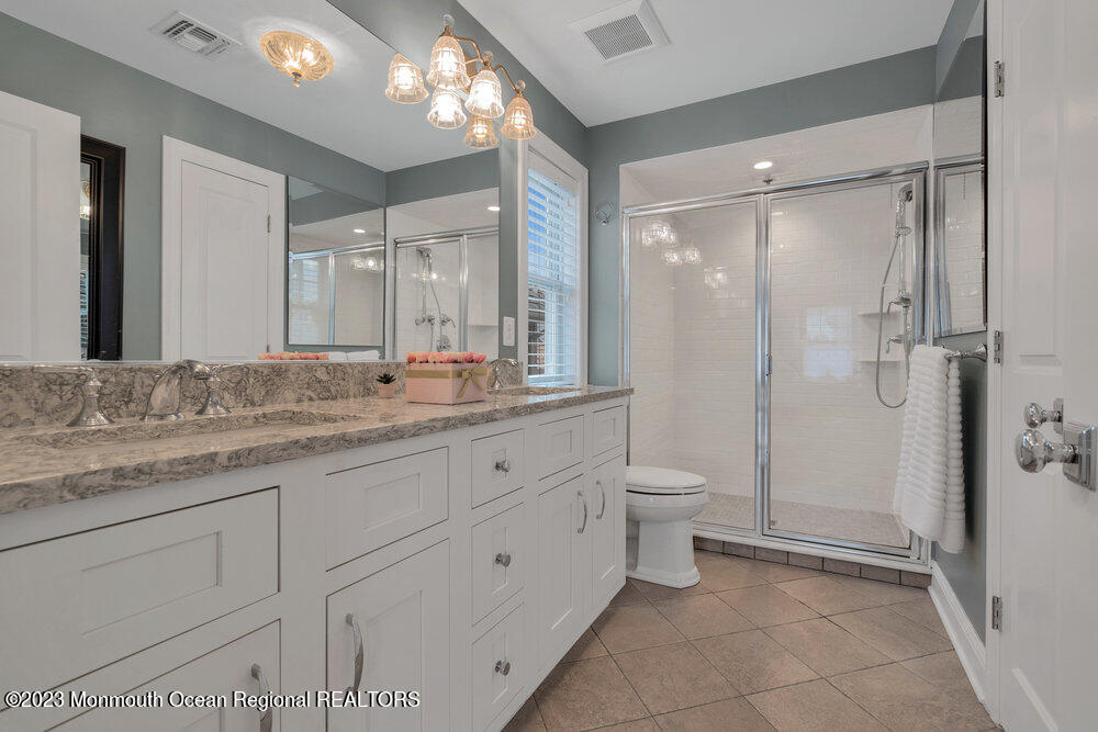 308 Morris Avenue, Unit A Spring Lake, NJ 07762 - Photo 20 of 37 a bathroom with a granite countertop sink toilet a large mirror a shower and a bathtub