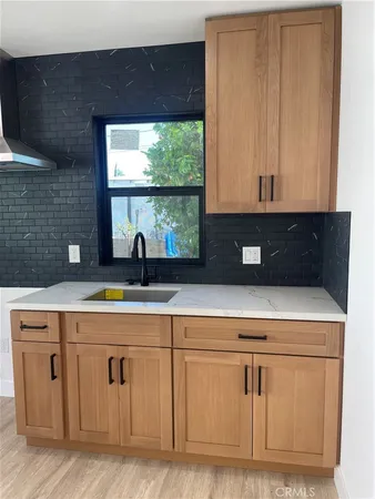 a view of cabinets a sink and a window