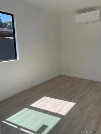 an empty room with wooden floor