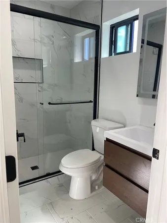a bathroom with a sink toilet and shower