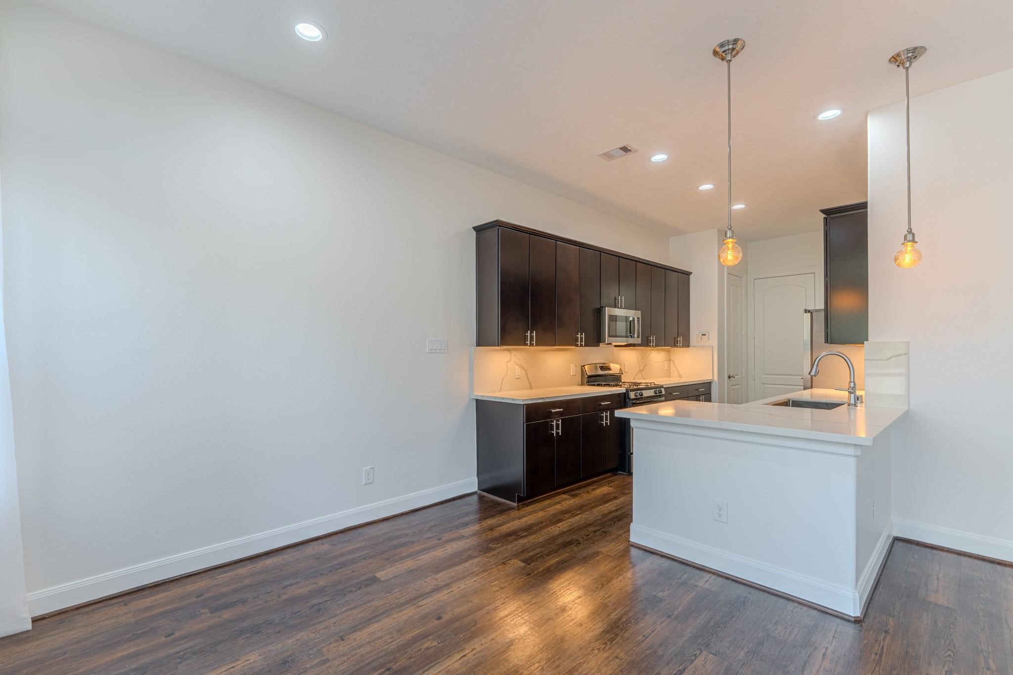 58 Aventura Place Spring, TX 77389 - Photo 10 of 23 a kitchen with a sink and a stove top oven