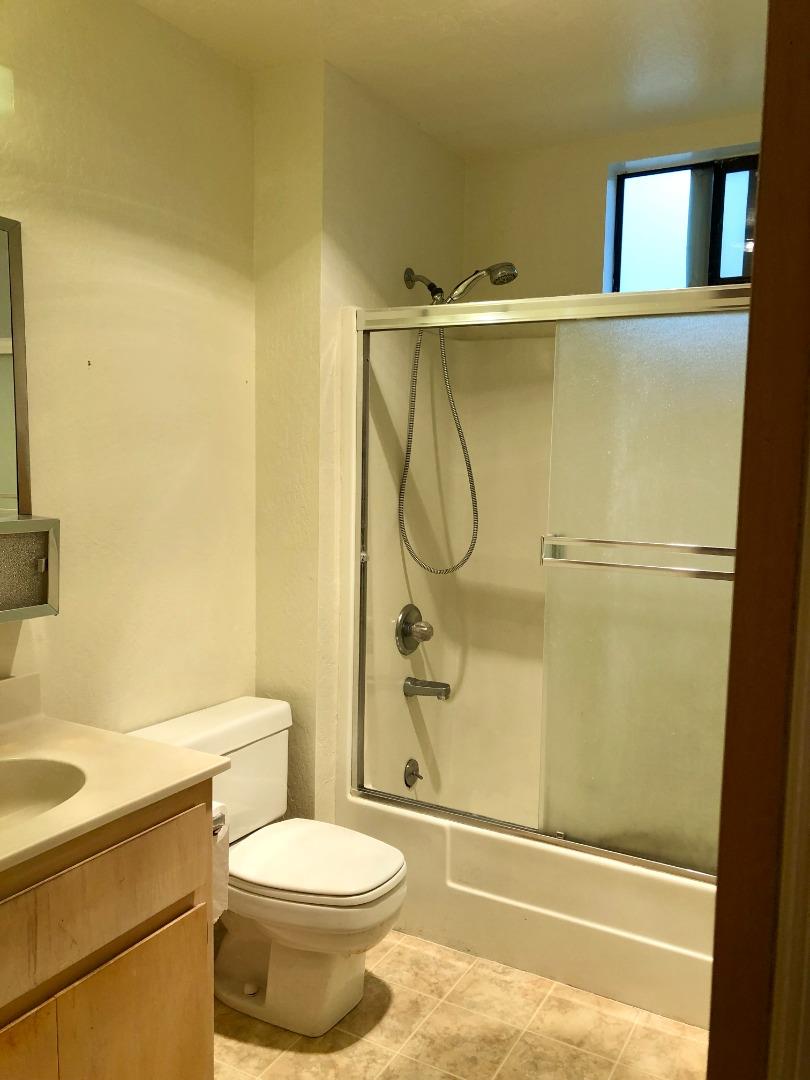 210-4 Broadway Millbrae, CA 94030 - Photo 11 of 15 a bathroom with a shower a toilet and a sink