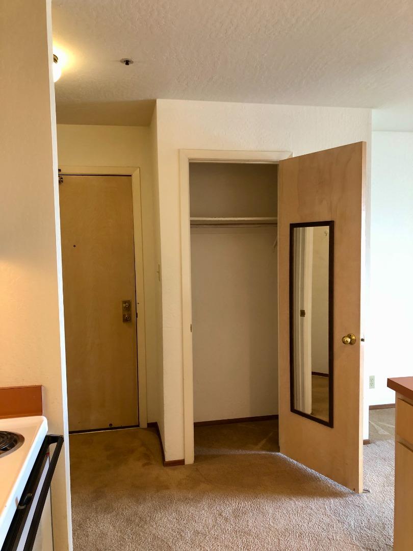 210-4 Broadway Millbrae, CA 94030 - Photo 8 of 15 a view of an empty room with wooden floor and a bathroom