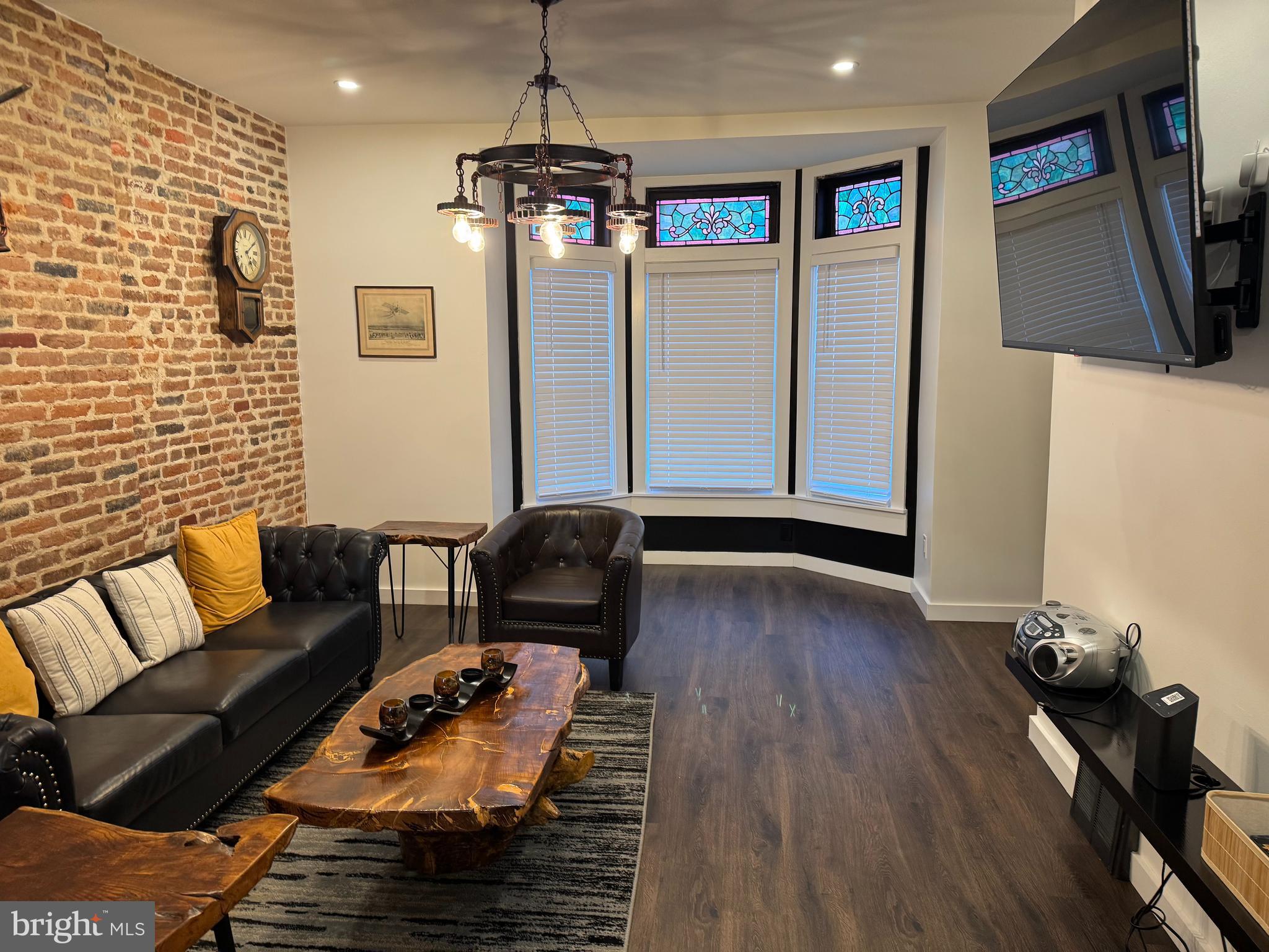 a living room with furniture and a flat screen tv