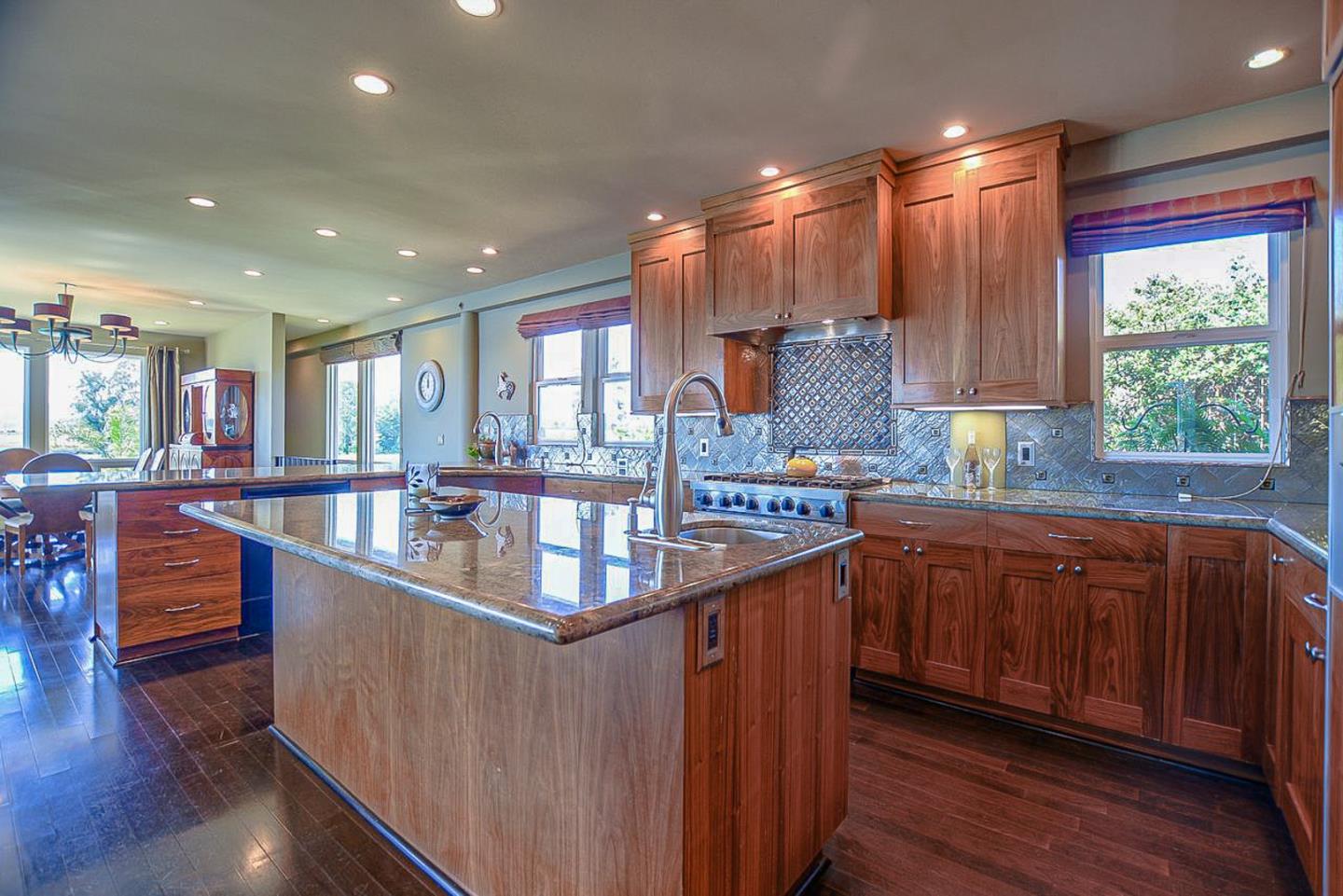 149 Cutter Drive Watsonville, CA 95076 - Photo 22 of 49 a kitchen with stainless steel appliances granite countertop sink stove and wooden cabinets