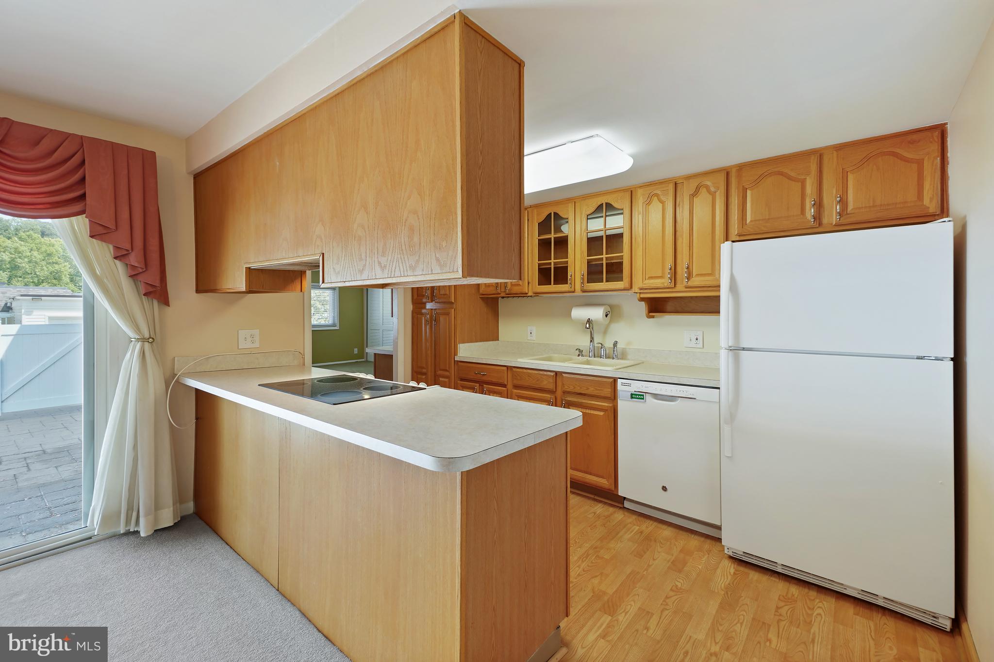 14550 Kelmscot Drive, Unit 186A Silver Spring, MD 20906 - Photo 11 of 29 a kitchen with a sink a stove and a refrigerator