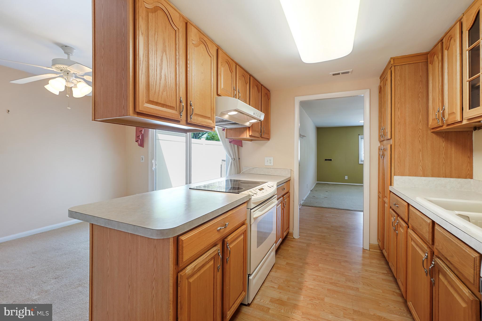 14550 Kelmscot Drive, Unit 186A Silver Spring, MD 20906 - Photo 12 of 29 a kitchen with stainless steel appliances granite countertop a sink and a stove