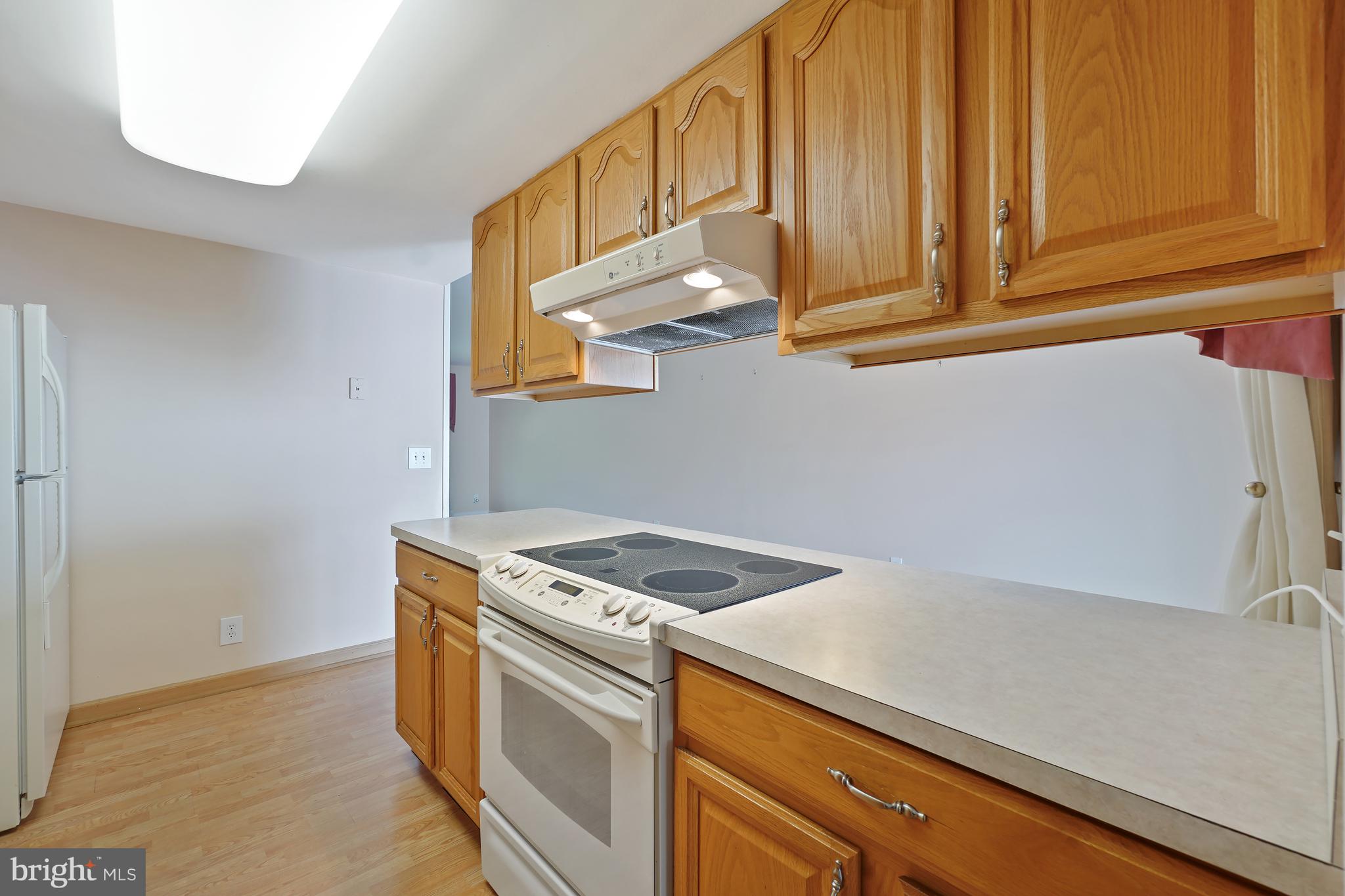 14550 Kelmscot Drive, Unit 186A Silver Spring, MD 20906 - Photo 15 of 29 a kitchen with stainless steel appliances granite countertop a sink and a stove