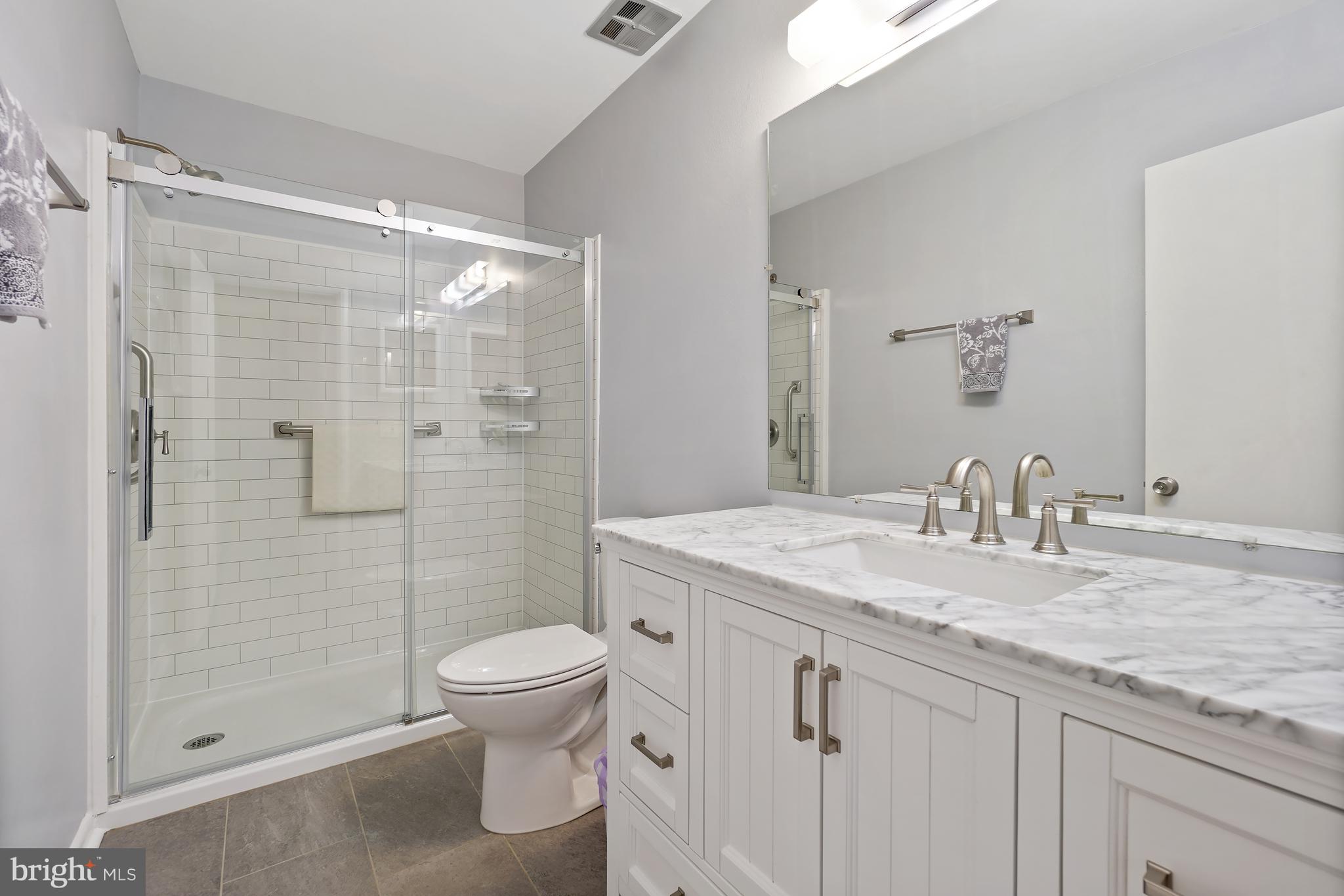14550 Kelmscot Drive, Unit 186A Silver Spring, MD 20906 - Photo 20 of 29 a bathroom with a granite countertop sink a toilet and shower