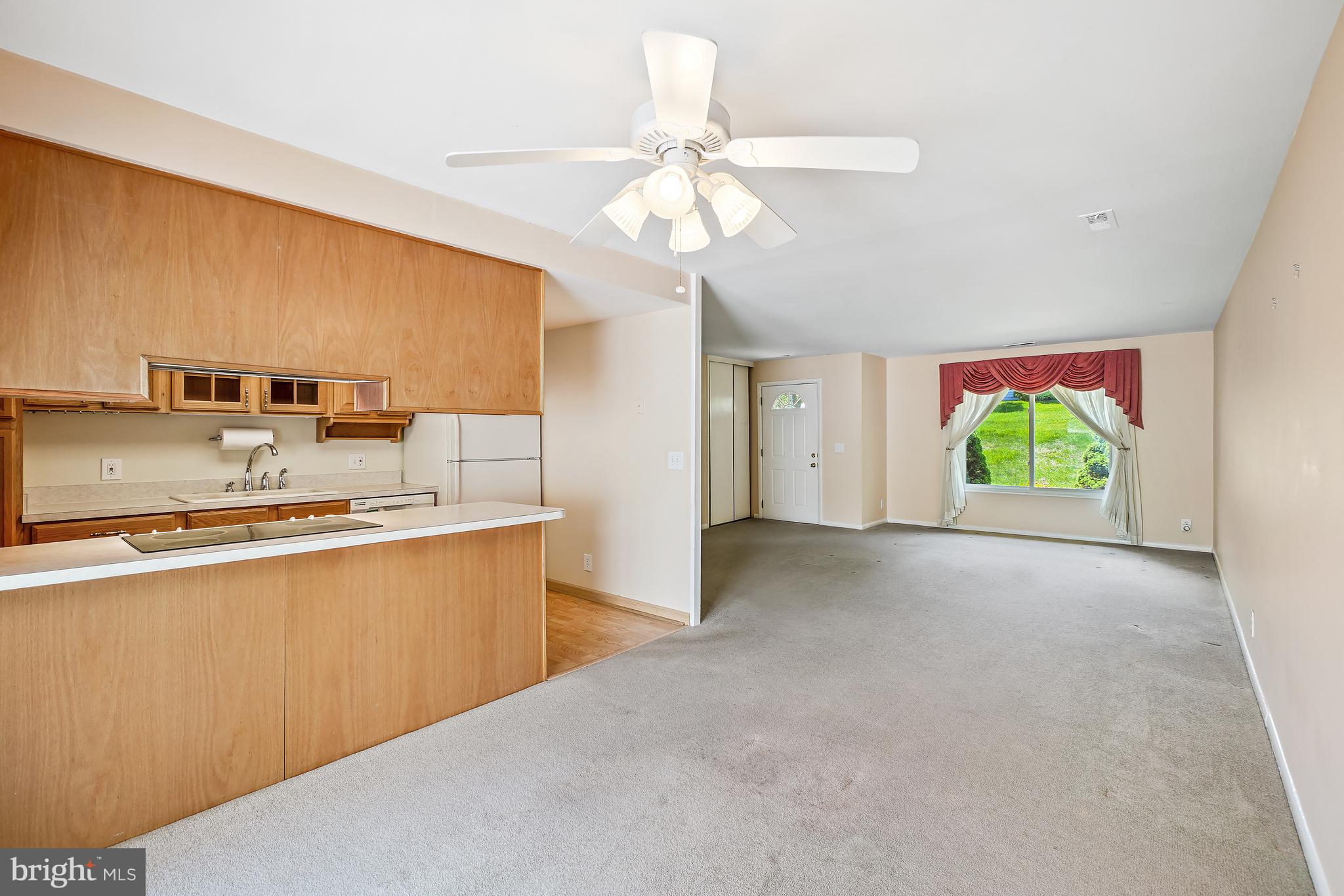 14550 Kelmscot Drive, Unit 186A Silver Spring, MD 20906 - Photo 10 of 29 a view of kitchen with kitchen island a stove a refrigerator cabinets and a sink