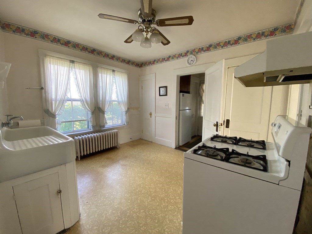 21 Trevalley Road Revere, MA 02151 - Photo 2 of 9 a kitchen with stainless steel appliances granite countertop a sink stove and refrigerator